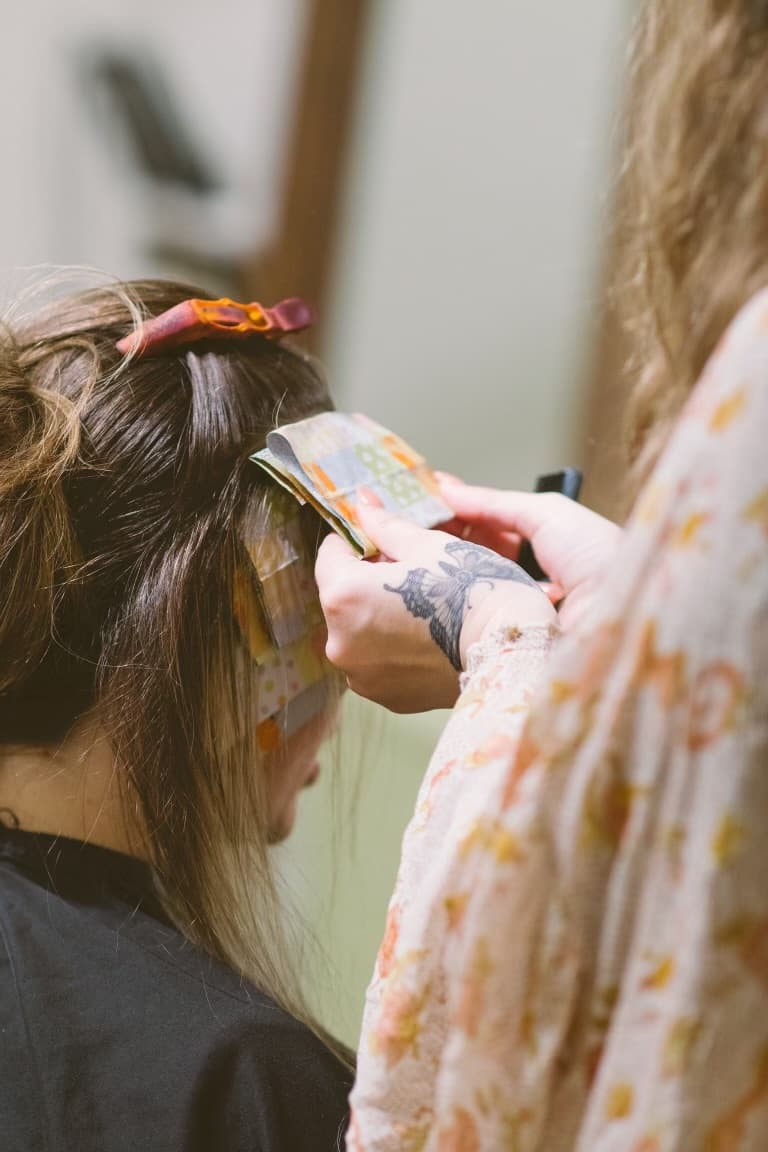 A close detail of color being brushed through hair