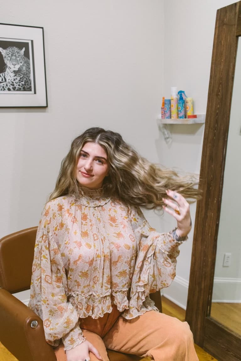 McKenzie seated in the studio with loose blonde waves